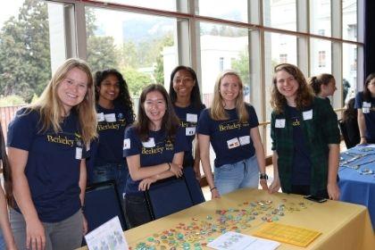 Smiling students in Berkeley Study Abroad shirts at fair