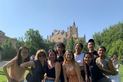 group of students standing in front of castle in Spain