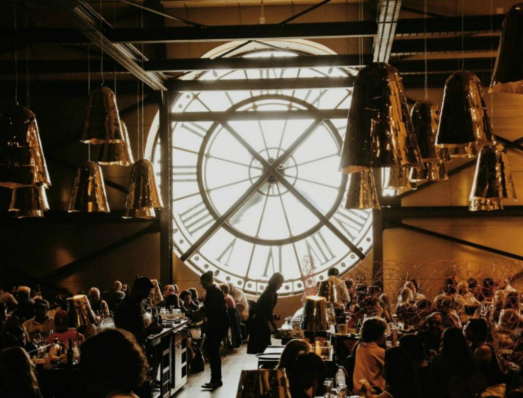 Inside a restaurant overlooking the clocks of Musee d'Orsay.