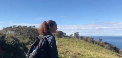 Screen Shot of woman looking over landscape from Asia's video about Australia