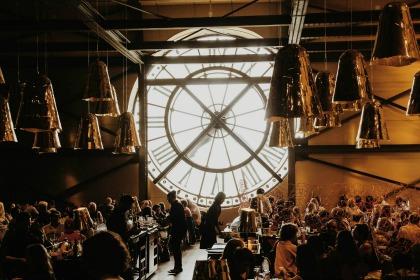 Inside a restaurant overlooking the clocks of Musee d'Orsay.