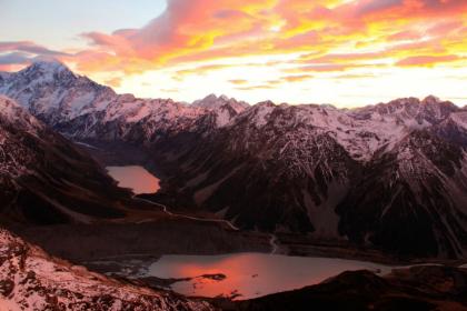 Sunrise creates a colorful sky in the Southern Alps