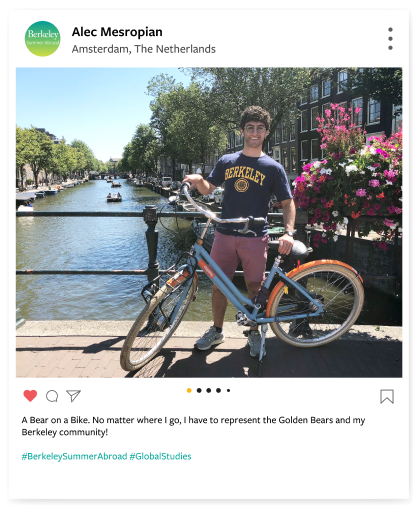 Berkeley student with a bike on a sunlit bridge in Amsterdam