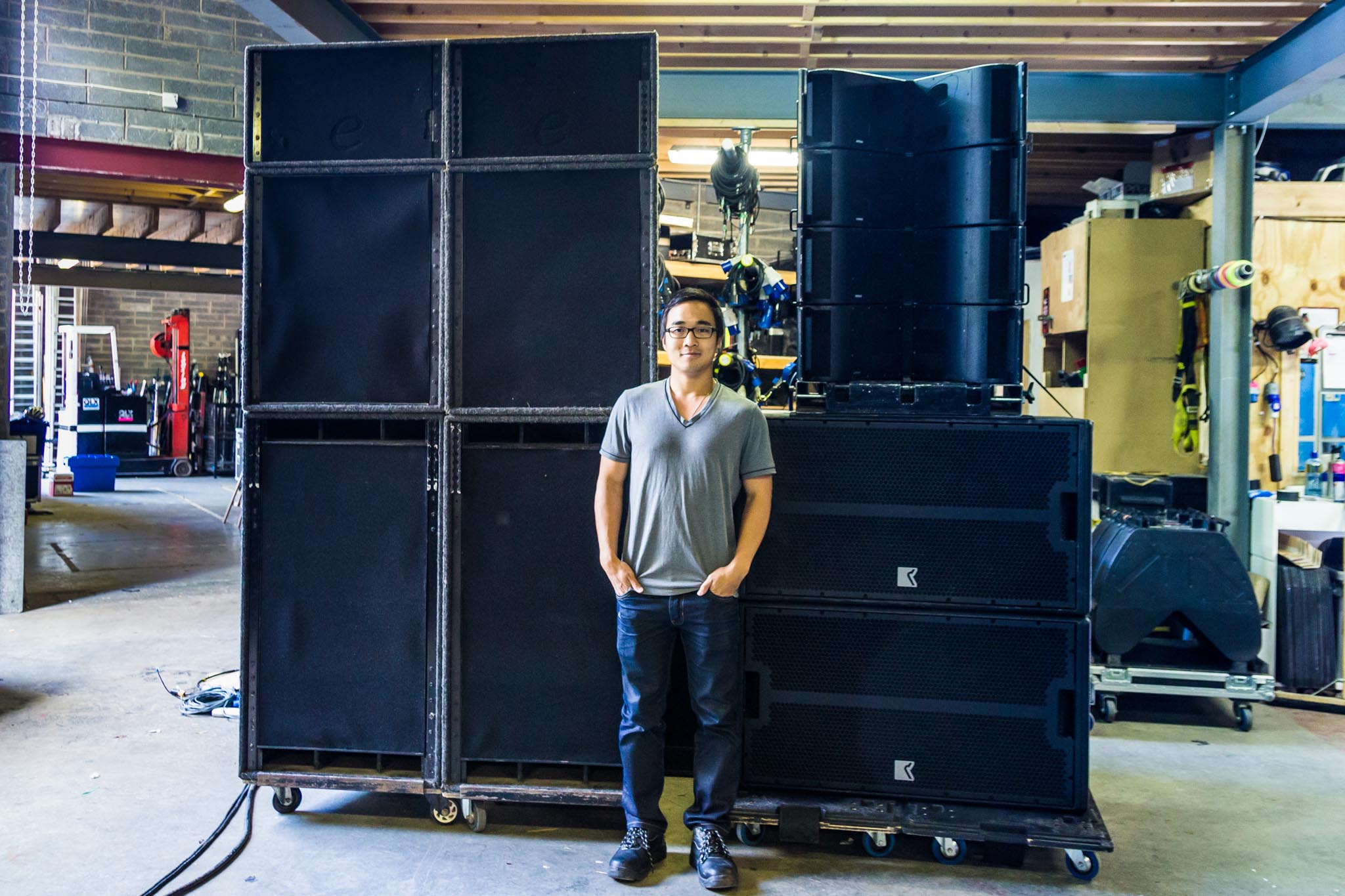 Student standing in front of speakers