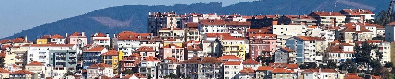 Multiple apartment buildings with mountains in the background