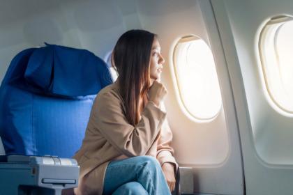 Person looking out of an airplane window