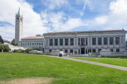 Photo of UC Berkeley library with Campanile in the background.