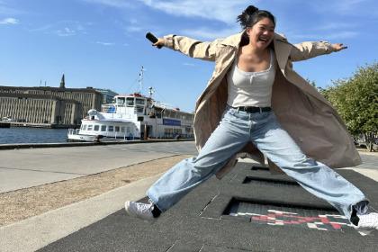 Student jumping on trampolines that are embedded in sidewalk in Denmark