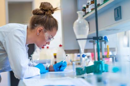Student in lab writing notes