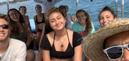 Laura on a boat amongst a group of fellow travelers