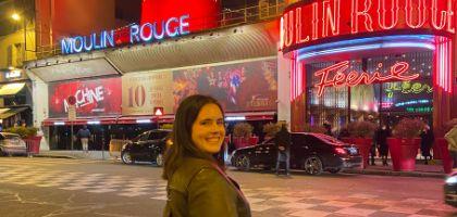 Jordan smiling at camera with Moulin Rouge in the background