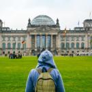 student looking at university building in Germany