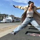 Student jumping on trampolines that are embedded in sidewalk in Denmark