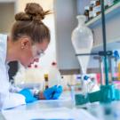 Student in lab writing notes